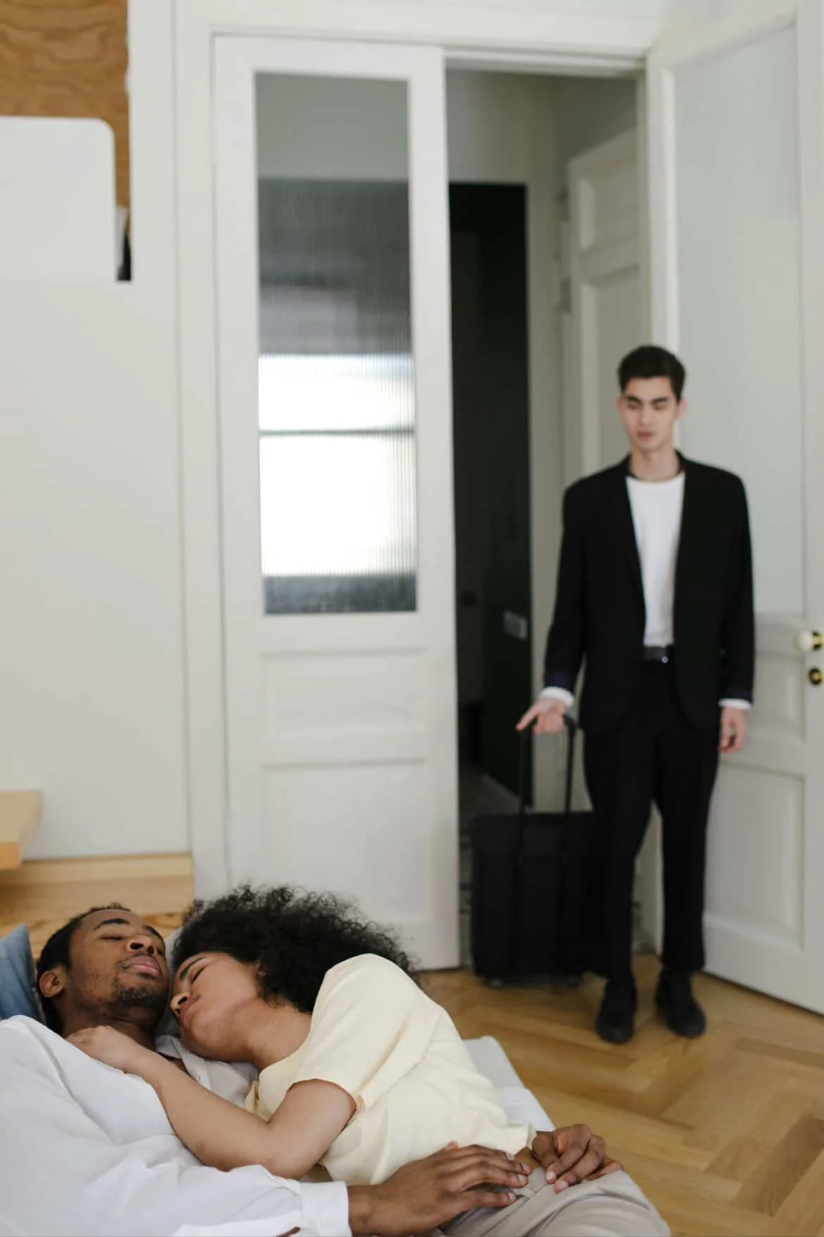 Private investigator observing a couple indoors during a relationship surveillance investigation